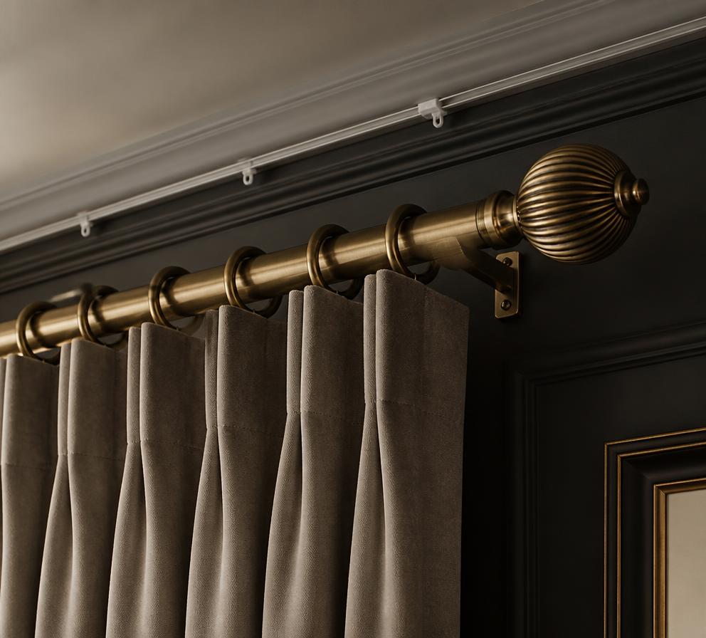 Antique brass curtain pole and ceiling track with pinch pleat curtains